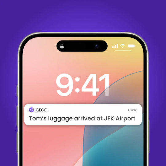 Smartphone with a notification about luggage arrival at JFK Airport on a gradient background